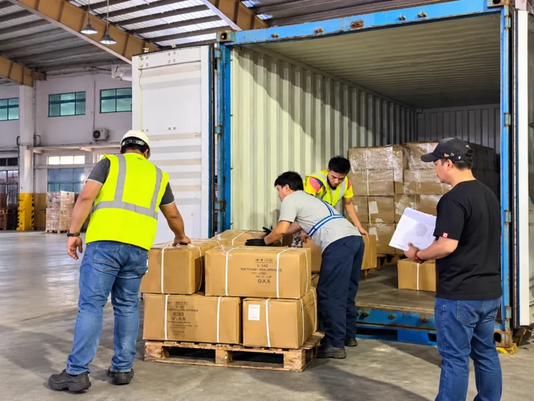 Warehouse team loading cartons into a shipping container